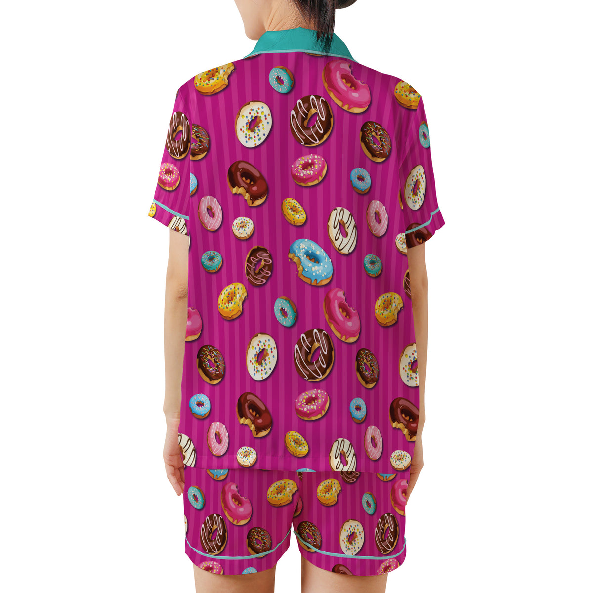 A person shown from the back wearing a matching short-sleeve pajama set with a bright pink striped base and an all-over donut print in multiple colors, photographed against a plain white background.