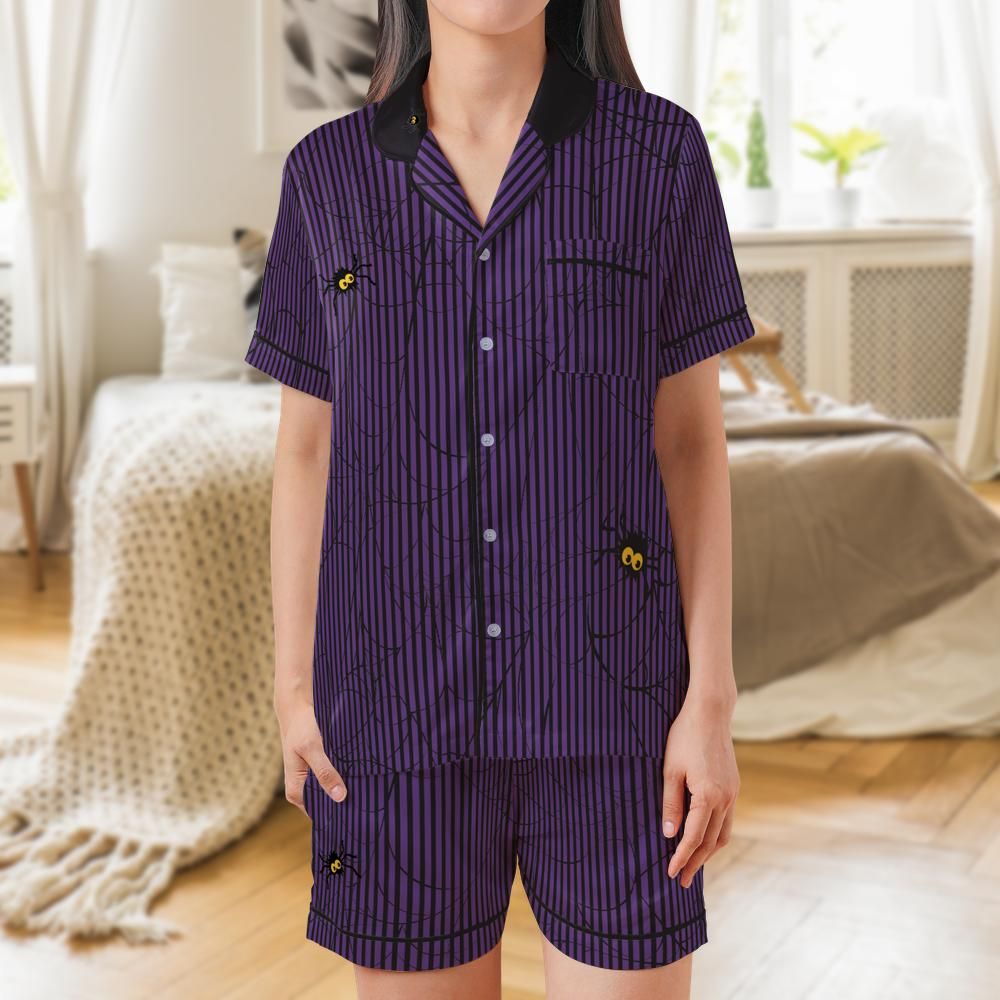 Purple and black pinstripe satin pajama set with spiderweb print and googly-eyed spiders