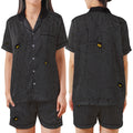 A woman modeling a matching short-sleeve button-up pajama shirt and shorts set, shown from the front and back. The set features a black and gray vertical stripe pattern overlaid with a spiderweb design and small yellow-and-black spider motifs.