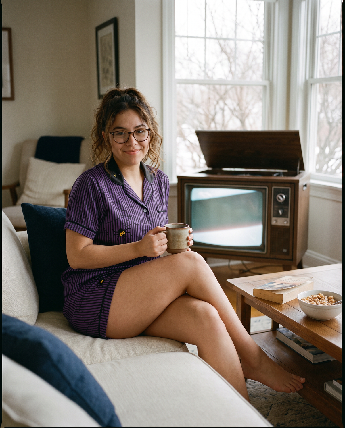 Purple and black pinstripe satin pajama set with spiderweb print and googly-eyed spiders