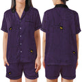 A two-piece pajama set shown on a model from the front and back, featuring a dark purple and black vertical stripe pattern with black spiderwebs and small yellow-and-black spider details.
